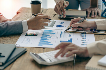 Analyzing business finance report on financial graph document during discussion at company meeting showing successful teamwork. Business Accounting Concepts close up pictures