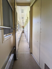 View from inside the passenger car of the train with a compartment.