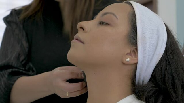 girl gets skincare treatment and make-up routine, make-up artist, beauty salon, MUA, pretty woman, cinematic shot, latina arab, brown hair, perfect face, commercial model, Cosmetic Brush Female 