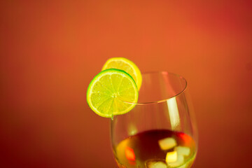 cold alcohol drink with slices of lemon and lime