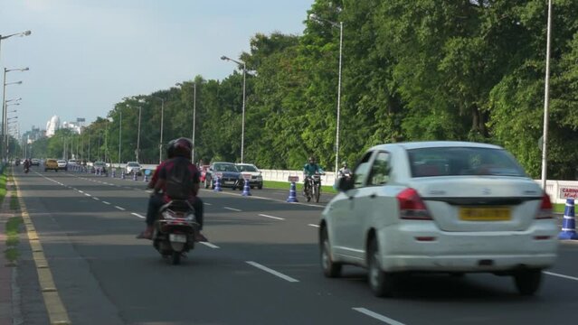 9th July, 2023, Kolkata, West Bengal, India: POV of a bike rider of morning traffic movement on Red Road and beautiful cityscape of Kolkata.