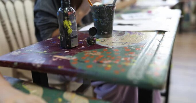Children draw at their desks in an art school, close-up. Classical drawing education, creative skills