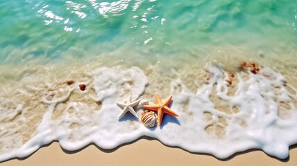 Fototapeta premium Shells and star on sand beach near wavy turquoise sea water. Beach vacation concept background.