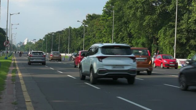 9th July, 2023, Kolkata, West Bengal, India: POV of a bike rider of morning traffic movement on Red Road and beautiful cityscape of Kolkata.