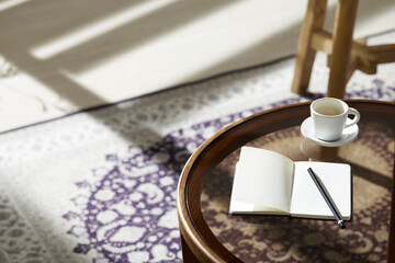 This room has a calm atmosphere with natural light.
There are clay pots, glass bottles, coffee and various objects on the table.
