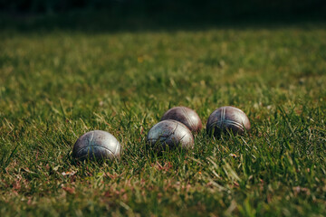 Famous simple game called petanque played in grass and sand. Spending time together with friends