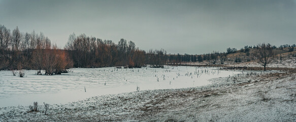 Snowy river shores and fields