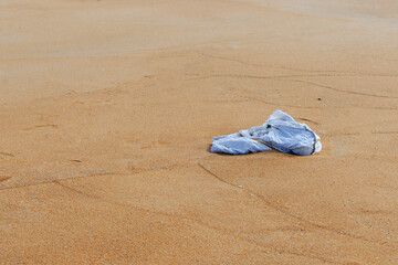 Fototapeta na wymiar Plastic bag are left on the beach as waste polluting nature, Plastic is hard to degrade, destroy the ecosystem, World environment day concept. Garbage spill on beach