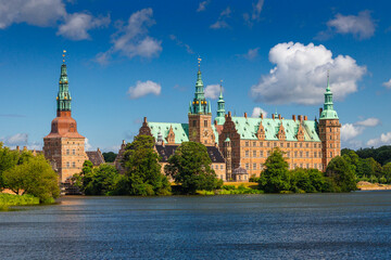 Naklejka premium Summer, sunny and warm view of Hillerod Castle in Denmark. There is a beautiful garden around the castle and it is worth visiting this place while in this area.