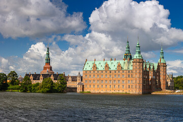Naklejka premium Summer, sunny and warm view of Hillerod Castle in Denmark. There is a beautiful garden around the castle and it is worth visiting this place while in this area.