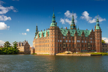 Fototapeta premium Summer, sunny and warm view of Hillerod Castle in Denmark. There is a beautiful garden around the castle and it is worth visiting this place while in this area.