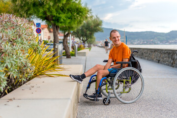 A disabled person in a wheelchair on the beach on summer vacation