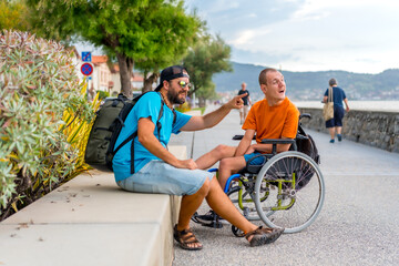 Disabled person in wheelchair with friends on summer vacation having fun