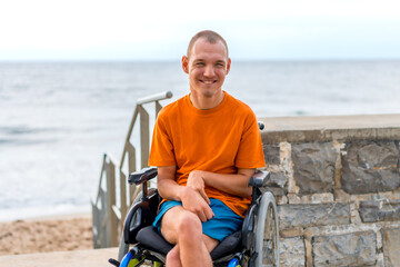 Portrait of a disabled person in a wheelchair on the beach on summer vacation