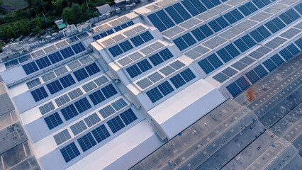 Aerial view of solar roof of the factory in eco environment. Solar Cells panel reflection with the sun and turn to blue color in industrial area. Concept of energy recycle.