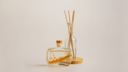 Reed diffuser bottle on the podium. Incense sticks for the home on white
