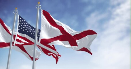 Flags of Alabama and the United States waving together