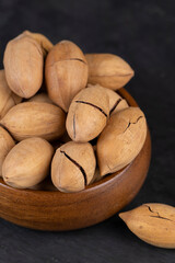 unpeeled pecans in a shell on the kitchen table