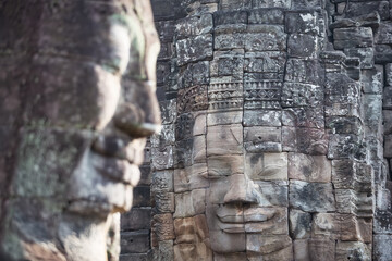 The stone faces of the khmer king on the wall of Bayon Temple, Angkor Thom, Siem Reap, Cambodia.