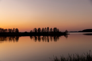 a beautiful reflection of the colorful sky in the water at sunset