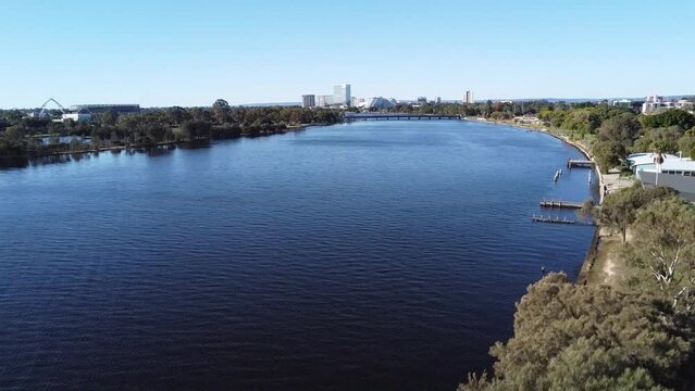 Drone shot descending with view of Optus Stadium, Crown Casino Burswood and Swan River down to paperbark tree in Perth, Western Australia