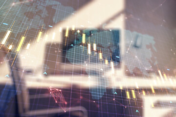 Double exposure of abstract creative financial diagram with world map and modern desk with computer on background, banking and accounting concept