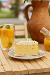 Aesthetics pumpkin slice of cake and natural sea buckthorn tea outside. Vegetarian recipe