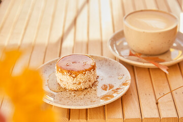 Healthy carrots no baking and no sugar light dessert with agave syrup. Gluten free cake with cup of coffee outside under shadows