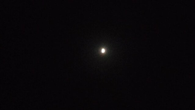 Part of the moon shining on a gloomy summer night in the clear skies of the Canary Islands