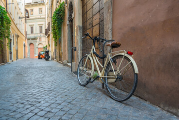 Fototapeta na wymiar Narrow street with an old bicycle