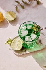 Non alcoholic healthy detox lemon, lime green sparkling mocktail. Vitaminized healthy drink. Green...