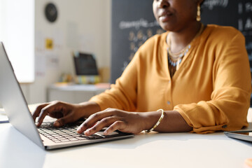 Close-up of African American teacher working on laptop at school