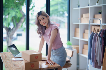 Portrait Of Asian Female Owner Of Fashion Store Clothing Store successful happy smile at small business, sme or ecommerce concepts