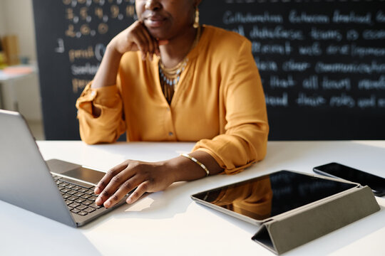 Close-up of African American teacher using gadgets at her work at school