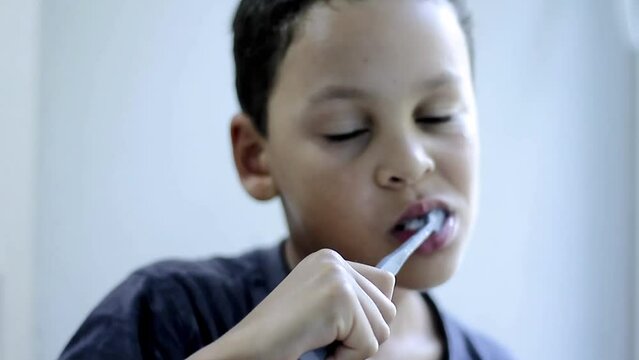 boy brushing his teeth with tooth brush with grey background stock video stock footage