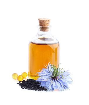 Black cumin oil with seedes and nigella flower on white background