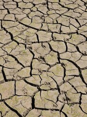 The bottom of a dried-up dam has cracked due to lack of water