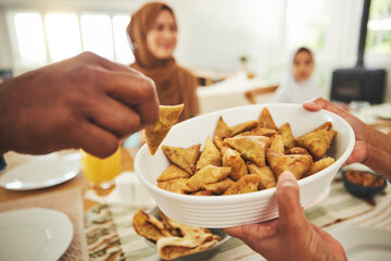 Food, samosa and muslim with hands of people at table for eid mubarak, Islamic celebration and lunch. Ramadan festival, culture and iftar with closeup of family at home for fasting, islam or religion