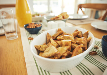Food, Eid Mubarak and samosa for family at table for Islamic celebration, festival and lunch together. Ramadan, religion and closeup of meal, dish and cuisine for fasting end, holiday and culture