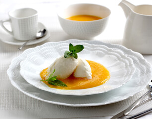 cheese ice cream quenelle on mango cream