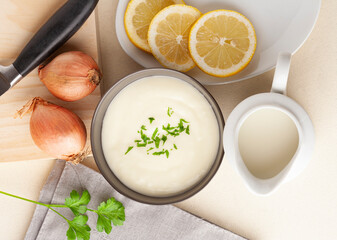 Bowl full of milk mayonnaise on wooden background concept healthy food..