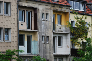 Old house with demolished balconies and weathered wall in Essen, Germany