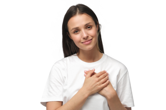 Portrait of smiling positive young woman keeps hands on chest, expresses sympathy. Kind hearted friendly nice female shows kindness