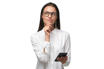 Young woman in white office shirt wearing eyeglasses and holding smartphone, making decisions and feeling doubt, looking away - 622285813