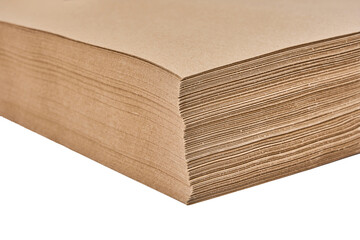 Stack of brown kraft paper sheets isolated on white background.