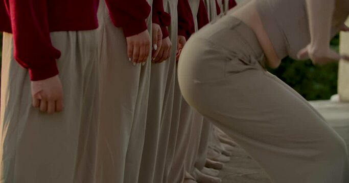 Beautiful contemporary interpretive dance by a big group of dancers outdoors, 4k