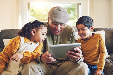 Young kids, grandfather and tablet, relax together and watch cartoon or e learning with games while at home. Bonding, love and spending quality time, old man and grandkids with gadget and internet