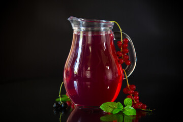Cold refreshing drink from fresh summer berries in a decanter.
