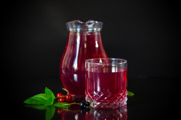 Cold refreshing drink from fresh summer berries in a decanter.