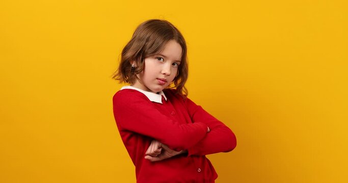 Serious teen school girl holds pencils in her hand in front of her and throws them